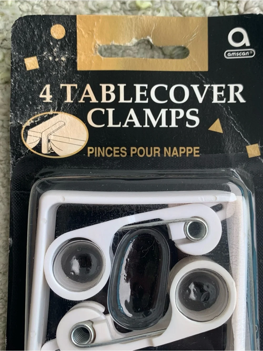 pack of four white Amscan tablecover clamps